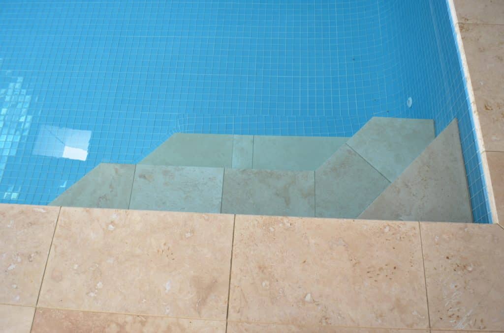 blue glass tiles with travertine pavers