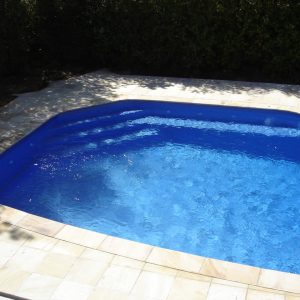 pool surrounded by natural suede sand paving