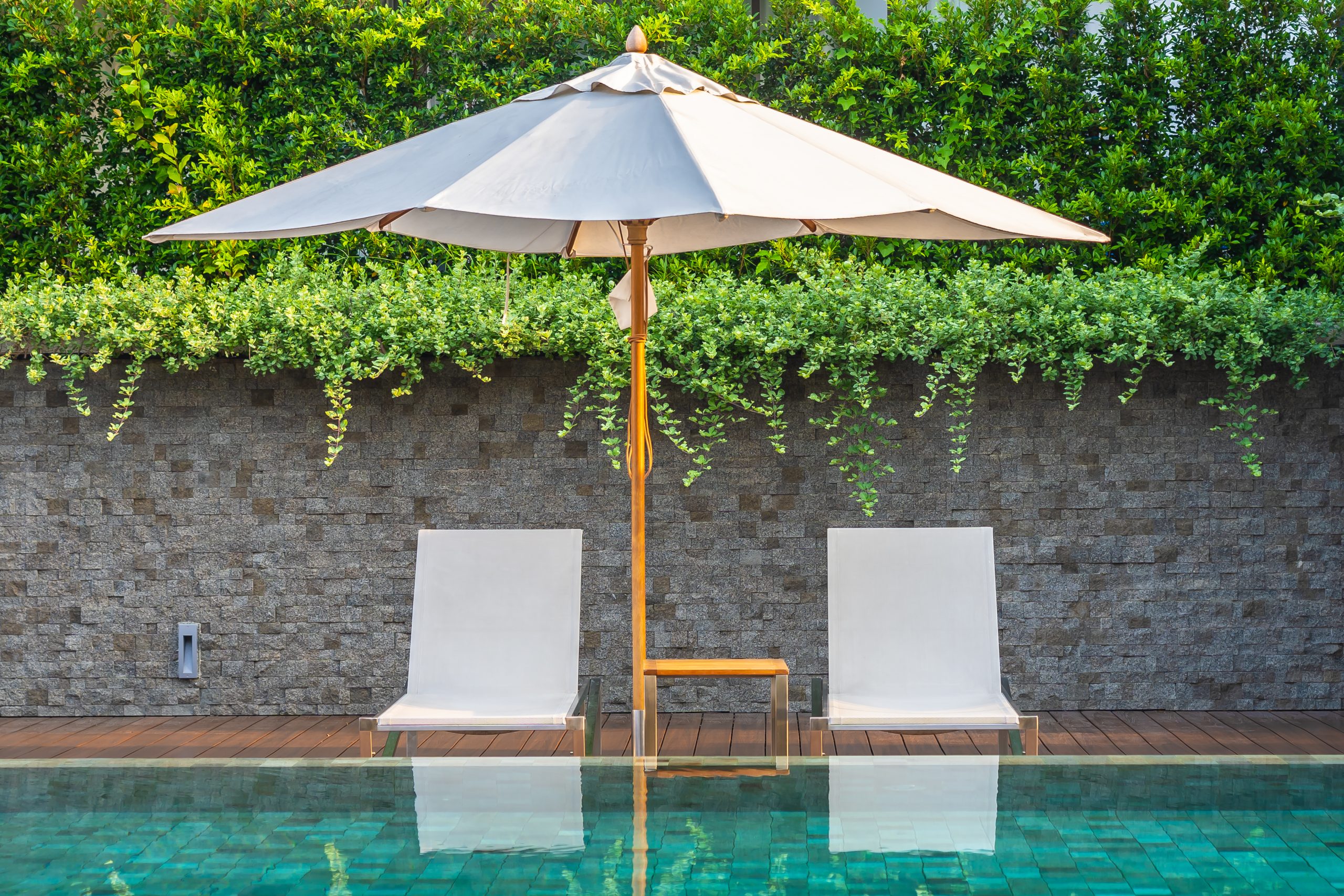 Outdoor swimming pool with umbrella chair lounge around there fo