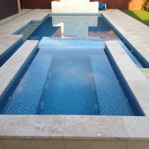 pool with classic travertine coping