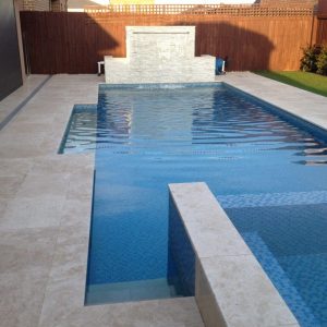 pool with classic travertine coping