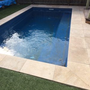 Classic dark travertine coping